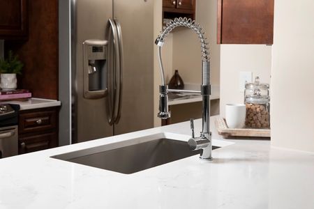 Vicostone Marble-Effect Quartz Counters, Deep Farm-style sink with single handle sprayer faucet