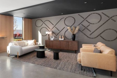 Lobby with comfortable seating and  celtic knotwork wall art at West End Yards | Portsmouth Apartments