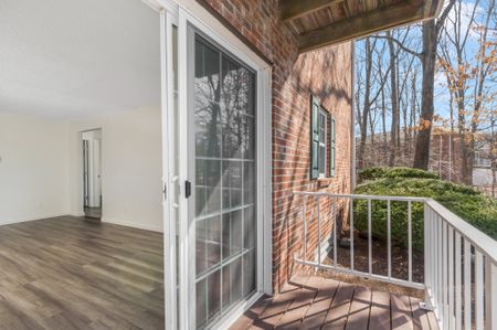 Living Room/Balcony at Woodview at Randolph Apartments in Canton