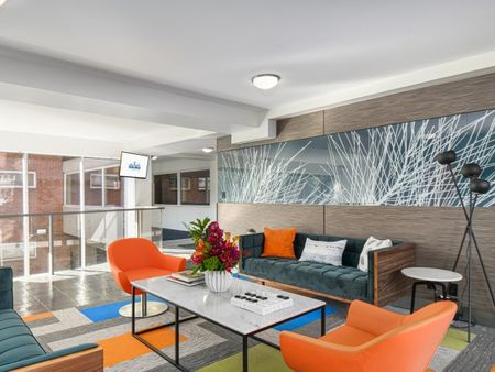Lobby with tables and seating at 100 Memorial Drive | Cambridge, MA Apartments for Rent