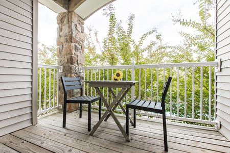 Balcony overlooking landscaping at The View at Mill Run | Owings Mills, Maryland Apartments