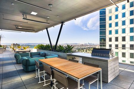 Apartments Downtown Oakland, CA-Eleven Fifty Clay- Oakland, CA-Dining Table, Outdoor Grill, Modern Outdoor Furniture, and Outdoor Seating.
