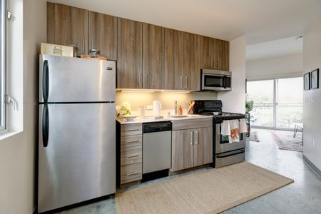 Kitchen with fridge, dishwasher, microwave and stove