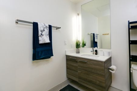 Bathroom vanity with hanging towel rack