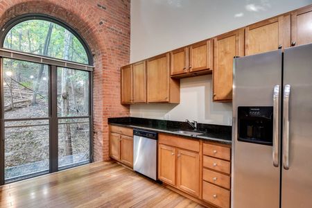 Kitchen with stainless appliances and large windows