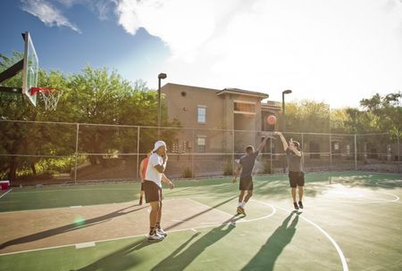 students playing basketball at ua off campus housing complex
