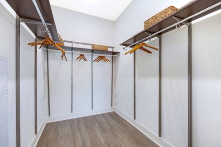 Walk-in closet with customizable racks and storage shelves.