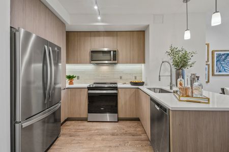 Representational Image of gourmet chef kitchen with stainless steel appliances, custom cabinetry, premium granite and quartz countertops with full-height backsplash