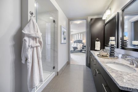 Spa-inspired bathroom with double-vanity, granite and quartz countertops and walk-in shower