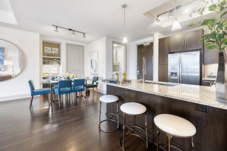 Open-concept floor plan with kitchen island, dining area and dry bar