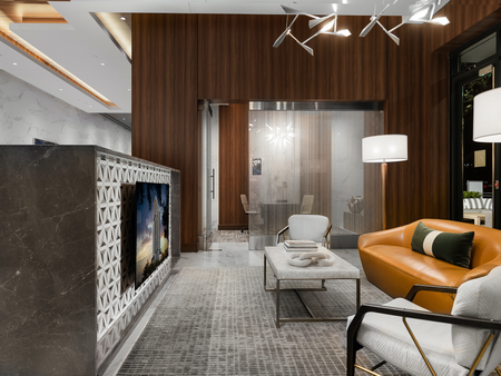 Private meeting area with a glass-walled conference room and a seating area with dark wood-paneled walls, a brown leather couch, two chairs and a flat-screen TV.