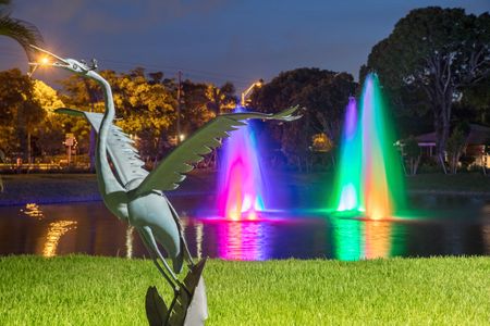 The Reserve at Coral Springs, exterior, dusk, buildings, rainbow fountains in pond