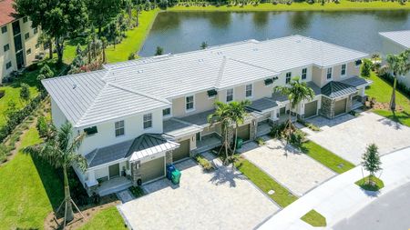 The Reserve at Coral Springs, exterior, aerial view of townhouses with garages, landscaped, pond