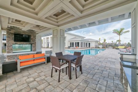 The Reserve at Vero Beach, exterior, sparkling blue pool, clubhouse, pavilion, lounge chairs, palm trees, our door seating, fireplace