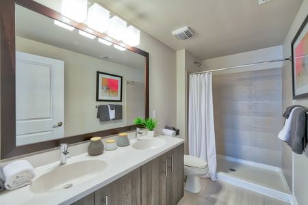 The Reserve at Vero Beach, spacious bathroom, double sink vanity, large mirror, shower, toilet