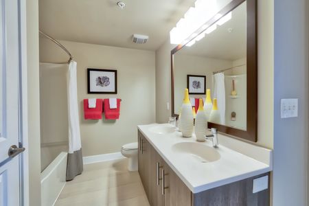 The Reserve at Vero Beach, interior, spacious bathroom, double sink vanity, large mirror, toilet, tub, shower, bright lighting
