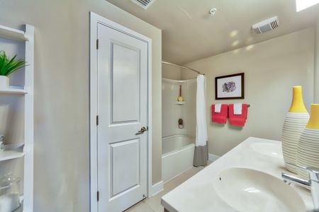 The Reserve at Vero Beach, interior, spacious bathroom, double sink vanity, large mirror, toilet, tub, shower, bright lighting, closet door