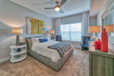 The Reserve at Vero Beach, interior, spacious bedroom, ceiling fan, carpet, bed, dresser, large window
