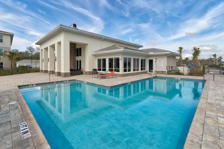 The Reserve at Vero Beach, exterior, sparkling blue pool, clubhouse, lounge chairs, palm trees