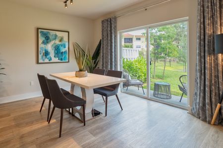 The Reserve at Coral Springs, interior, dining room, large sliding glass doors to patio, landscaped view