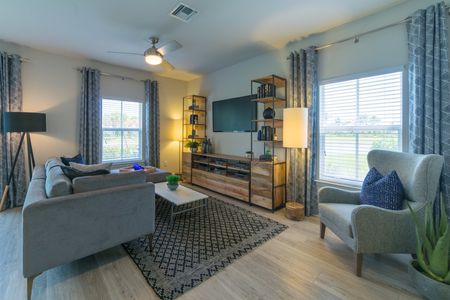 The Reserve at Coral Springs, interior, living room, large windows, natural light, stylishly furnished in grays and blues