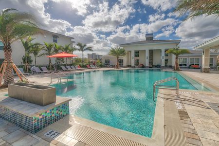 The Reserve at Coral Springs, exterior, sparkling blue swimming pool, clubhouse, lounge chairs, outdoor seating