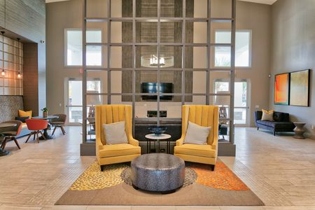 The Reserve at Coral Springs, interior, clubhouse, seating area, yellow arm chairs