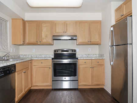 Updated Kitchens, Light Blonde Cabinets, Mahogany Style Plank Floors and Stainless Steel Appliances Canyon Park l Luxury Remodeled Apartments in Puyallup