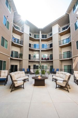 Coryell Commons 55+ courtyard with seating and fire pit