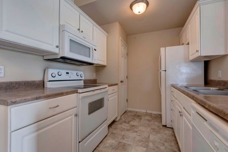 Coryell Crossing Apartments with white cabinets and white appliances