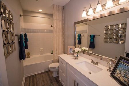 Furnished apartment bathroom with shower tub combo