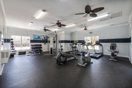 Apartment gym with free weights and cardio machines
