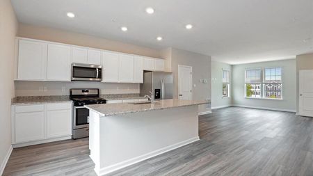 unfurnished kitchen and living area of townhome