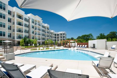 furnished pool area with apartment building at daytime