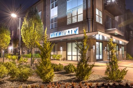 exterior apartment building with trees at nighttime