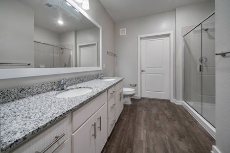 bathroom with stand up shower and dual vanity