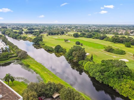 aerial view of lake and golf course on sunny day