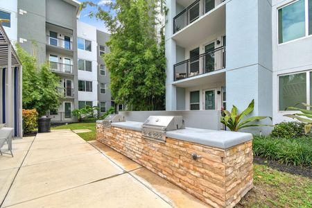 outdoor grilling station in front of apartment building in daytime
