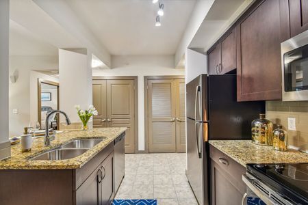 furnished kitchen area with island in apartment home