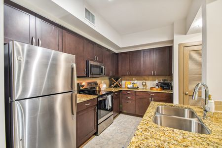 furnished kitchen area with island in apartment home