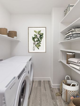 digitally furnished laundry room of apartment home