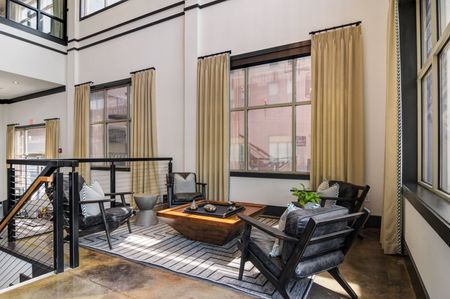 furnished clubroom with seating and tables
