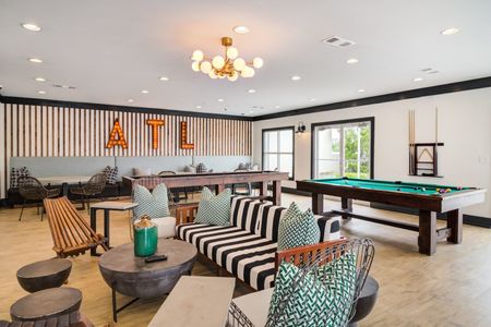 indoor furnished clubroom with gaming tables and seating