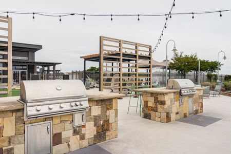 outdoor grilling area with streetlights on rooftop on sunny day