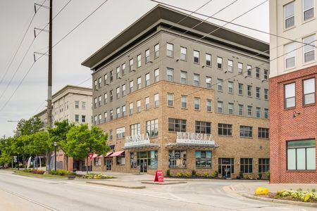 exterior apartment building on street corner on sunny day