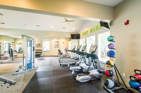 Fitness center with cardio equipment and windows