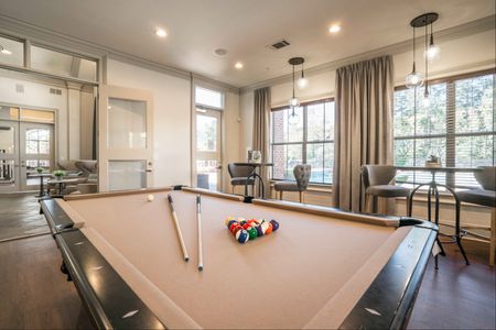 furnished clubroom with pool table and seating