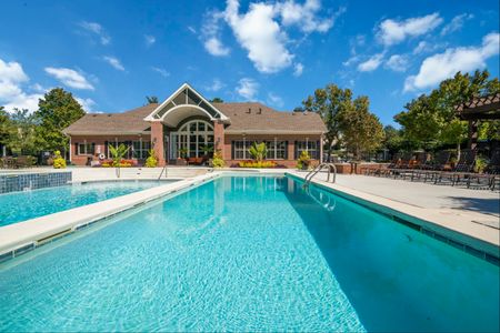 Two-BR Apartments in Duluth, GA - Parc 85 -Gated Pool Area with Lounge Chairs, Trees, and Clubhouse.