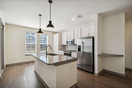 Bright and spacious kitchen with stainless steel appliances and island