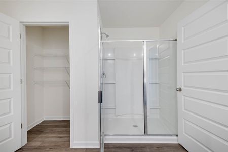 unfurnished glass shower with closet in bathroom in home